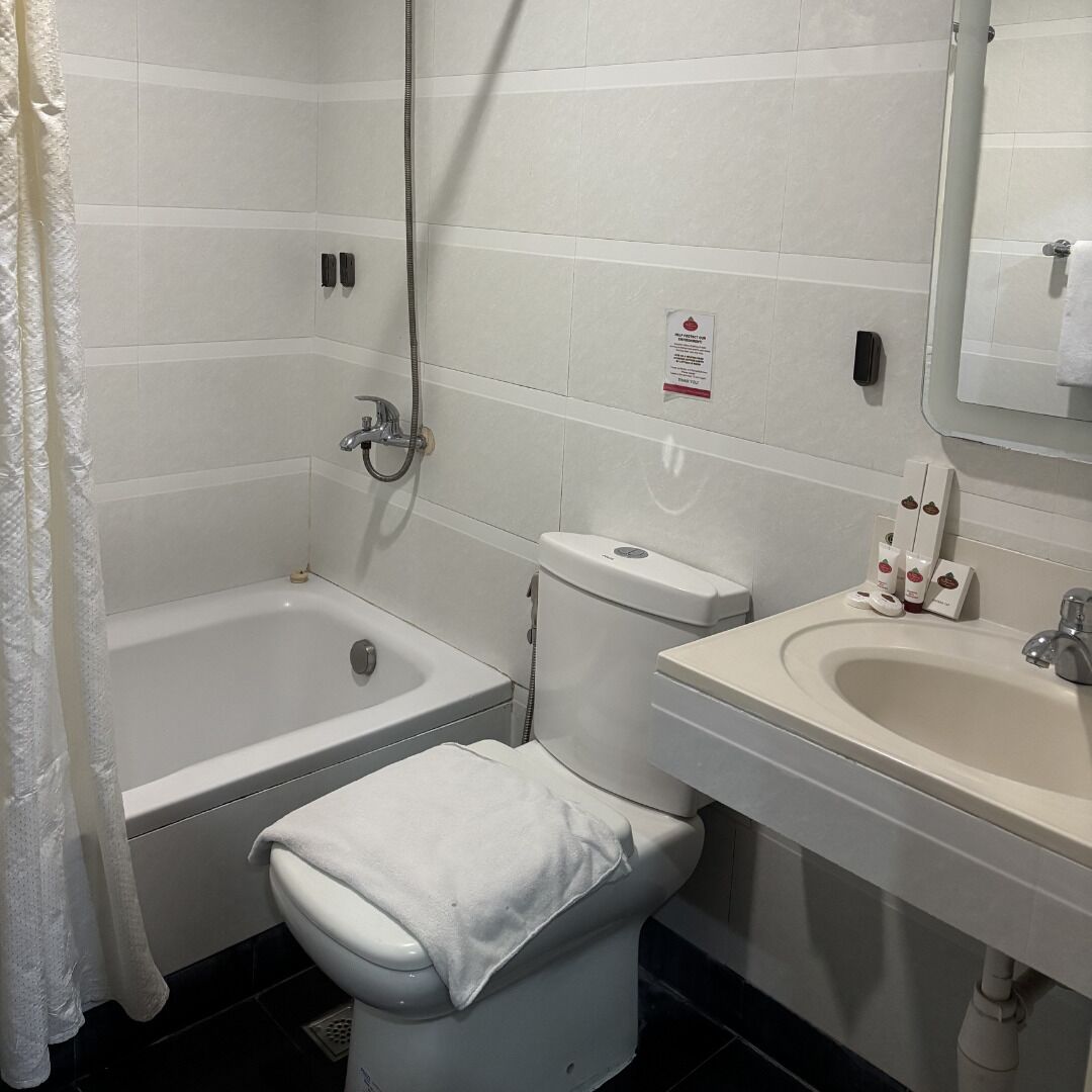 A bathroom with a bathtub, toilet, and sink.