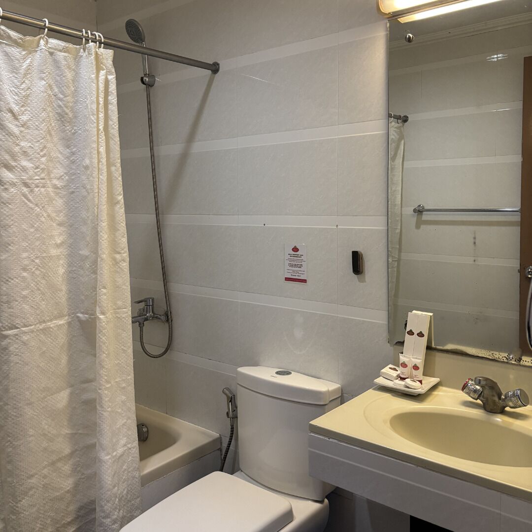 A bathroom with a bathtub, toilet, and sink.