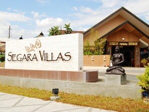 A sign for Segara Villas with a Buddha statue in front. - Segara Villas (Olongapo)