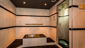 Relax in a spacious bathtub, surrounded by a visually appealing tile design.