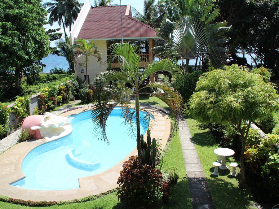 Een buitenzwembad en ligstoelen