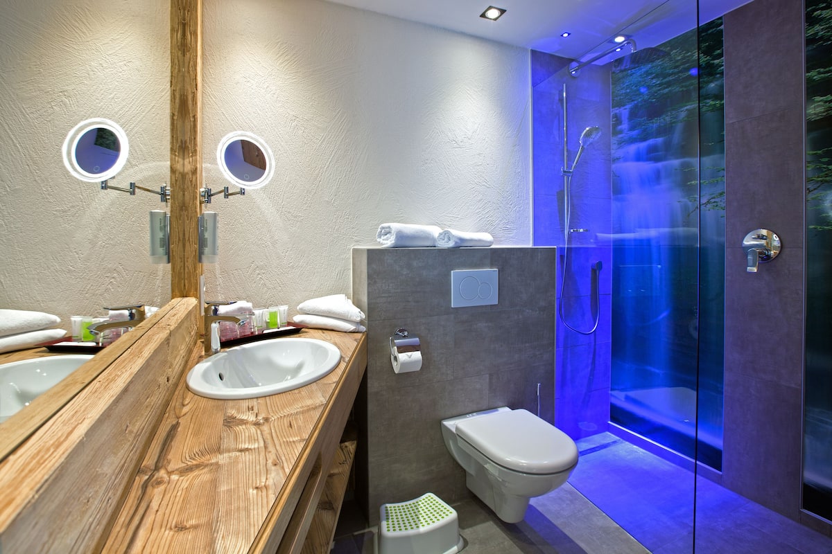 junior suite | bathroom | shower, free toiletries, hair dryer, bathrobes