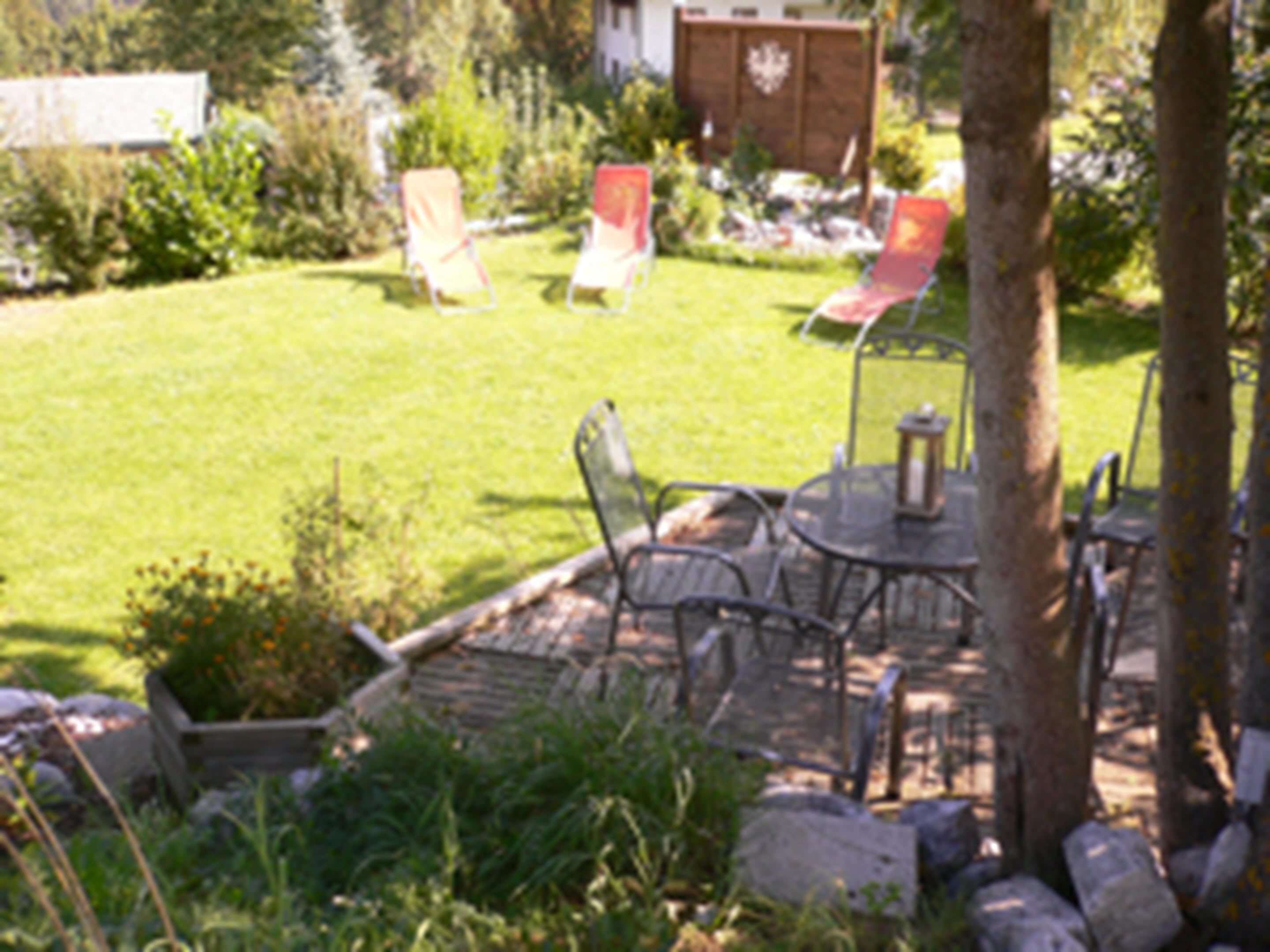 A patio area with outdoor furniture, a table, and a chair.
