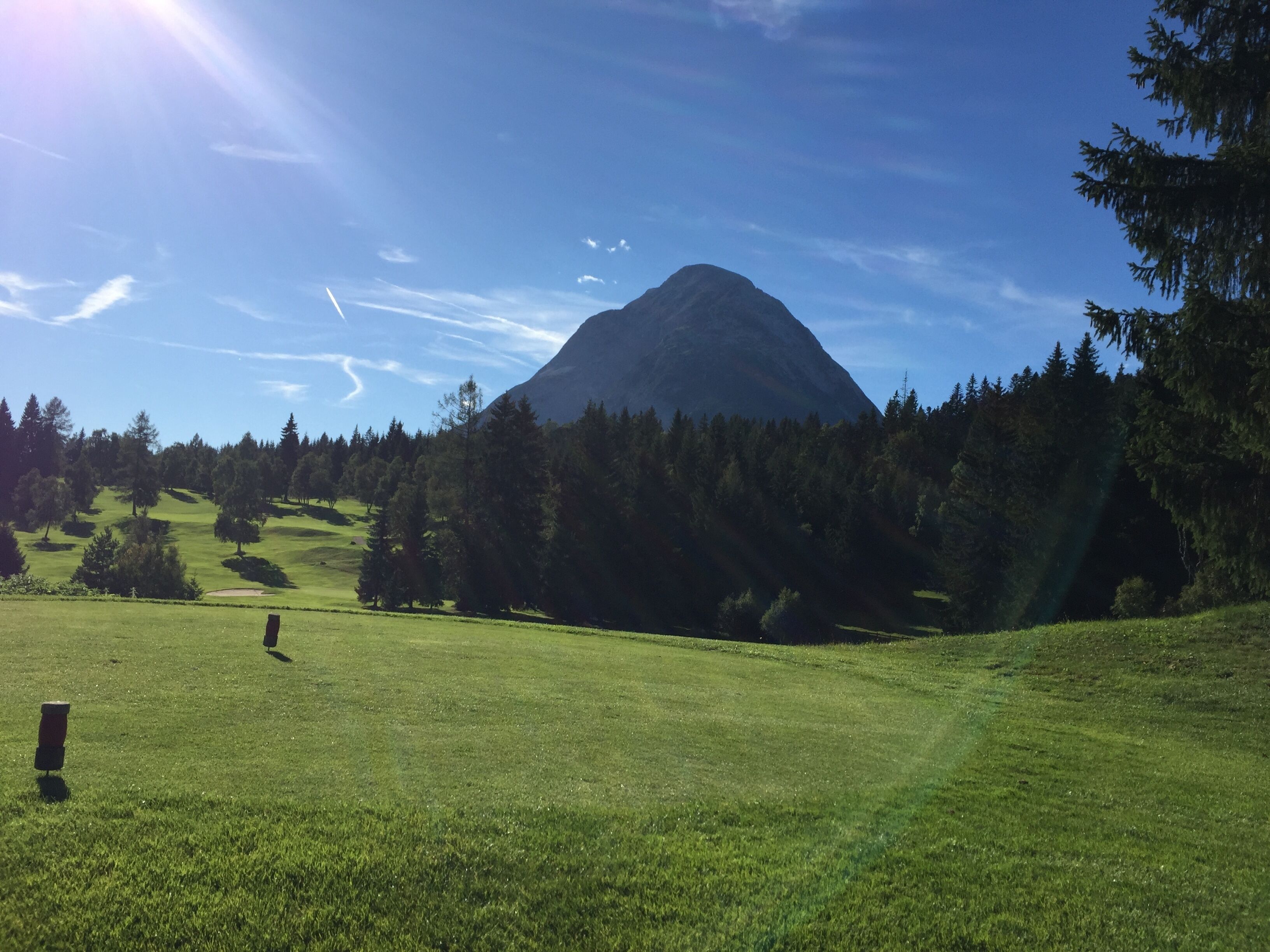 A golf course with a mountain in the background.