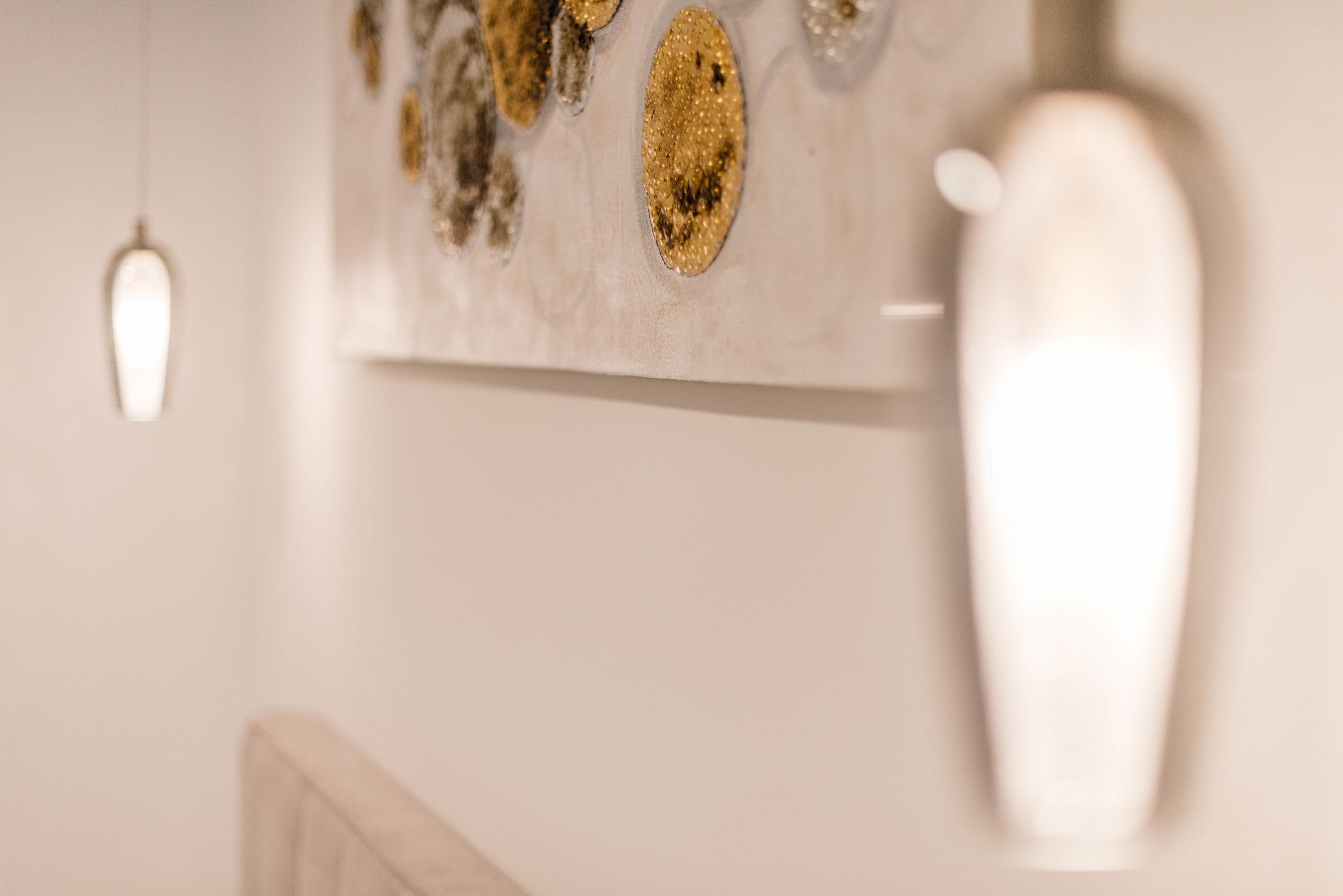 A wall with decorative elements and a hanging light fixture.
