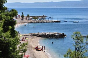 Beach nearby, white sand, beach umbrellas, beach towels