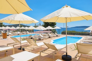Seasonal outdoor pool, open 10:00 AM to 6:00 PM, pool umbrellas
