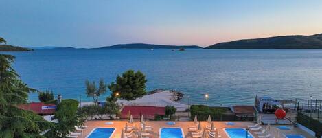Seasonal outdoor pool, open 10:00 AM to 6:00 PM, pool umbrellas