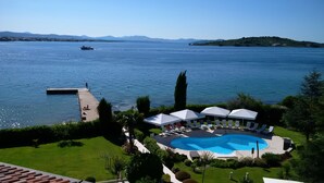 A resort with a swimming pool, lounge chairs, and a dock. - Hotel Villa Radin (Vodice)