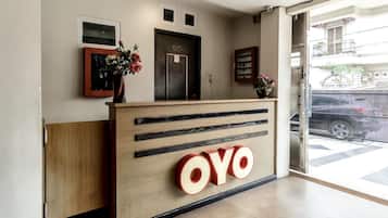 A reception desk with a wooden finish and a large 'OVO' sign.