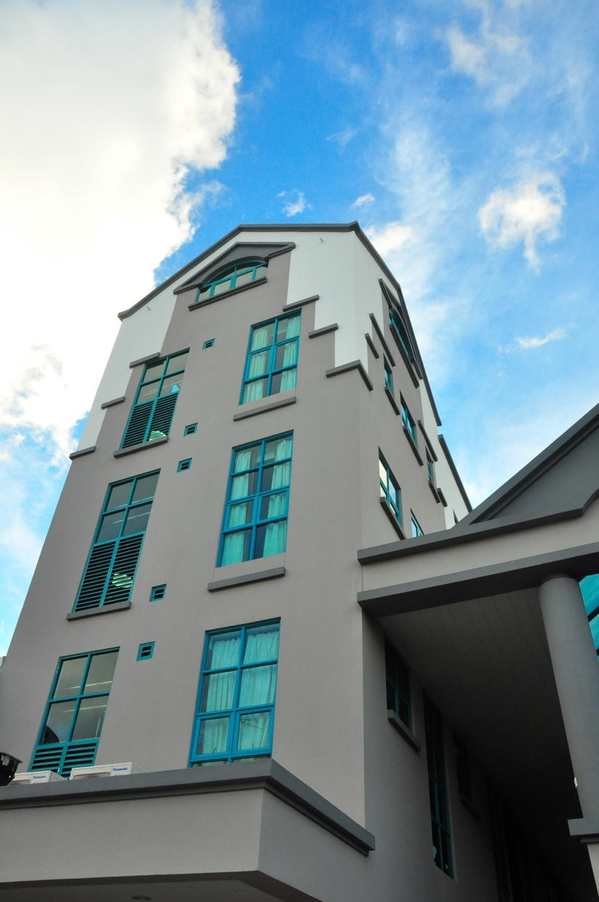 A multi-story building with a modern architectural design, featuring a series of windows and a flat roof.