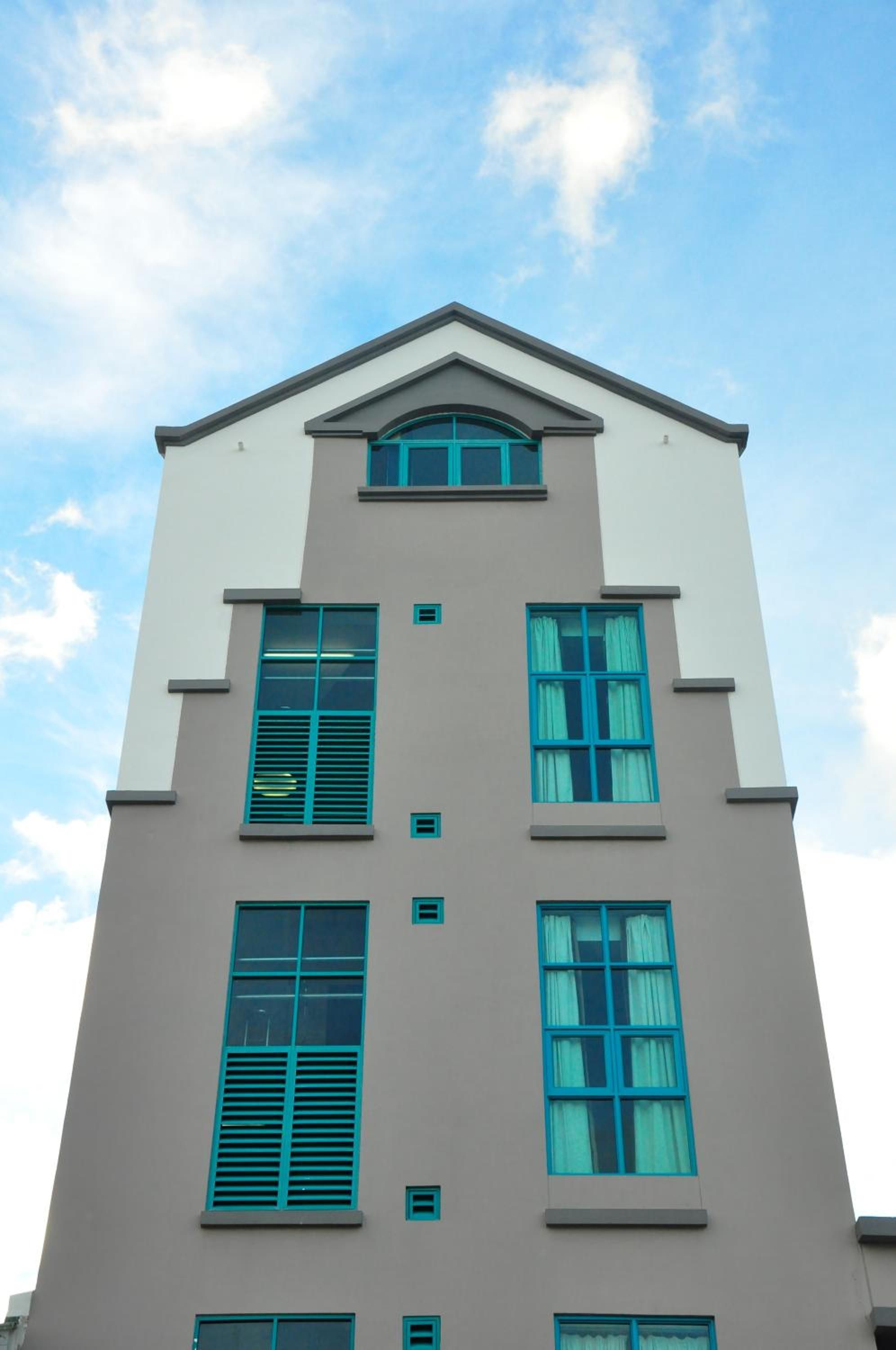 A multi-story building with a symmetrical facade, featuring a central entrance and evenly spaced windows.