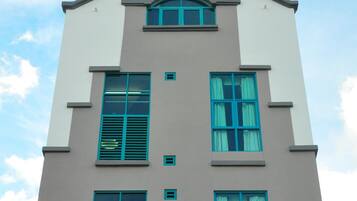 A multi-story building with a symmetrical facade, featuring a central entrance and evenly spaced windows.