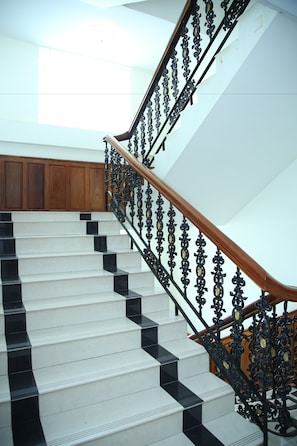 A staircase with black and white steps and ornate black railings. - Holiday Hotel (Battambang)