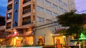 A multi-story hotel with balconies, a prominent "HOLIDAY HOTEL" sign, and a well-lit entrance. - Holiday Hotel (Battambang)