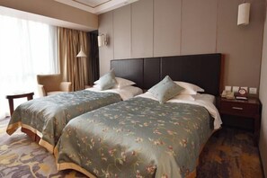 A hotel room with two beds, a chair, a nightstand, and a lamp. - China Hall of Science and Technology (Beijing)