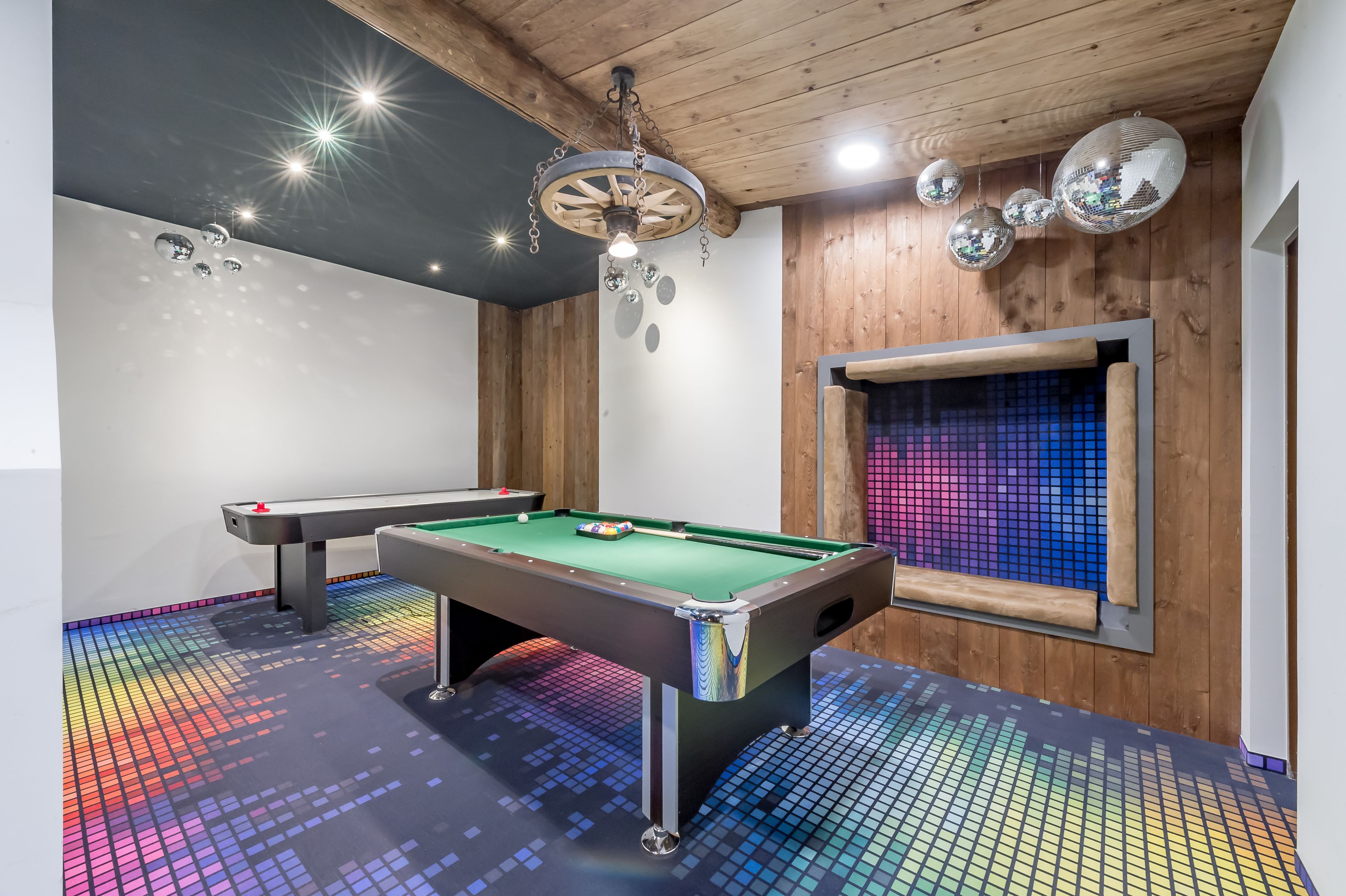 Ein Billardtisch mit farbigem LED-Boden, Holzboden und Discokugeln.