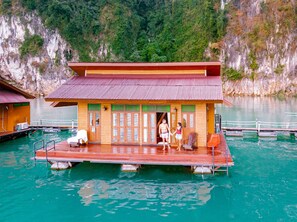 A floating wooden structure with a red roof, a covered seating area, and a small table. - Panvaree Resort (Ban Ta Khun)
