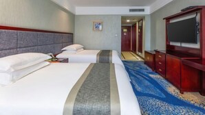 A hotel room with two beds, a flat-screen TV, a wooden desk, and a carpeted floor. - Enshi International Hotel (Enshi)