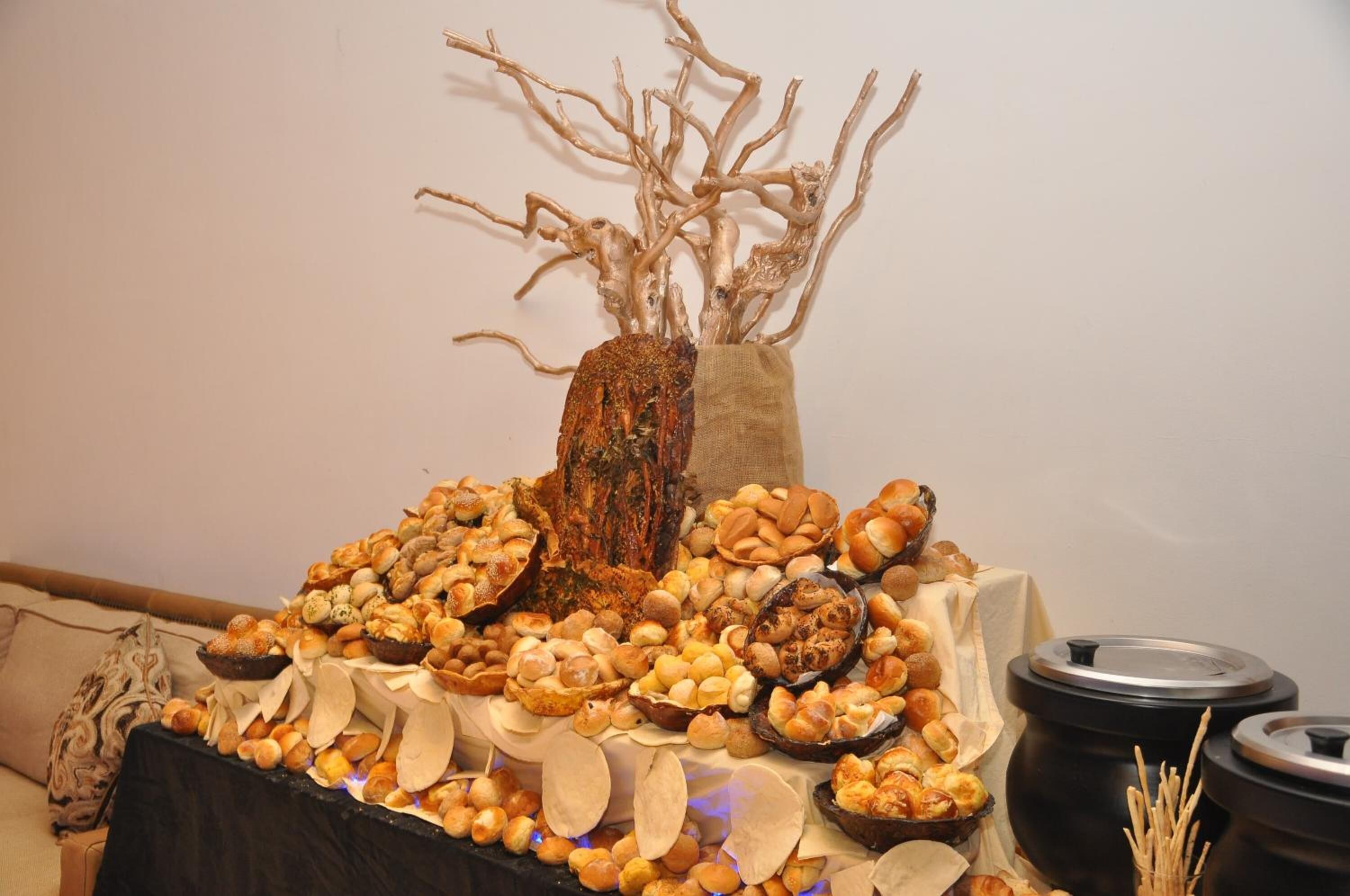 A table with a variety of breads and pastries.