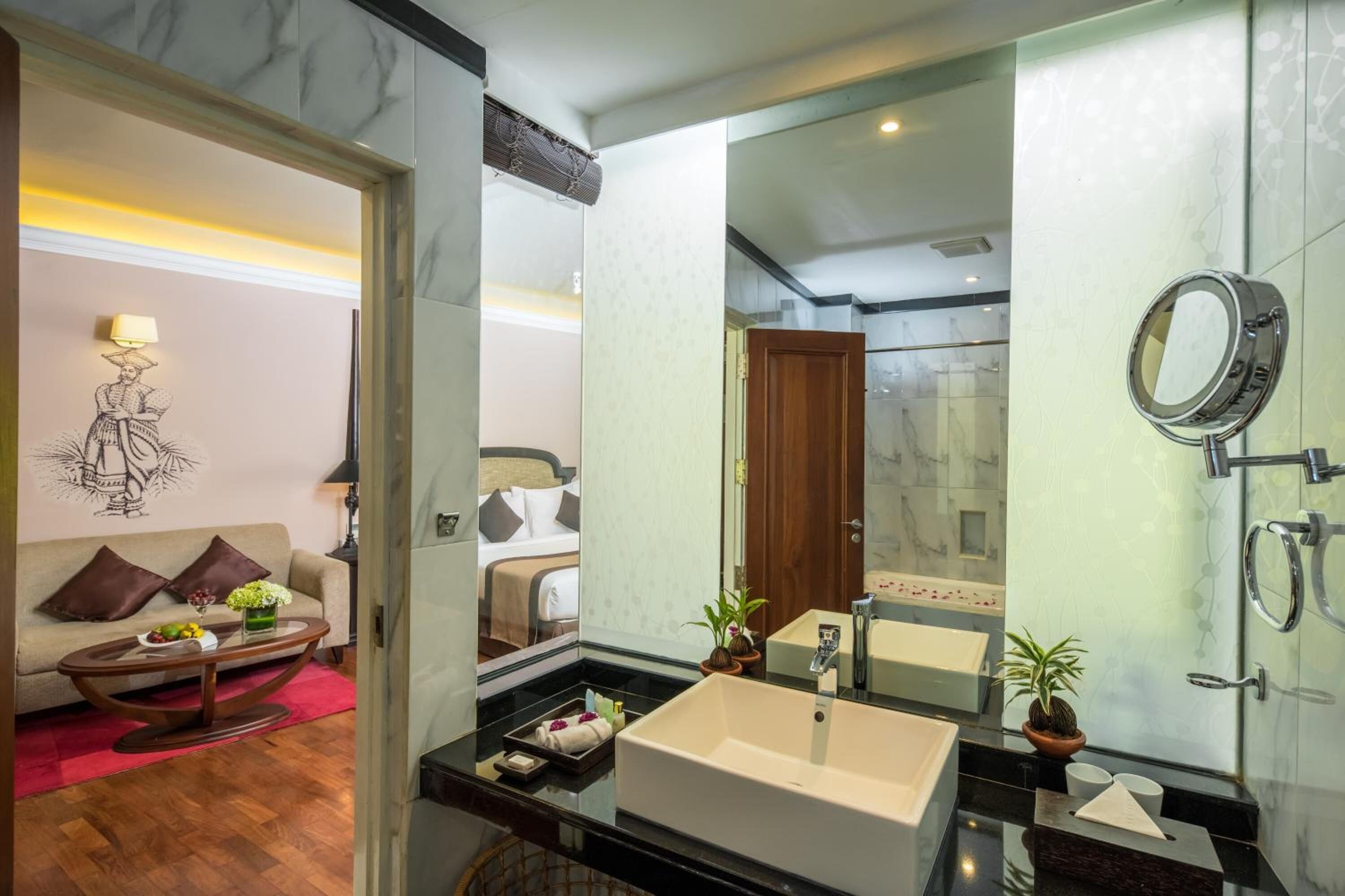 A modern bathroom with a large sink, mirror, and shower.