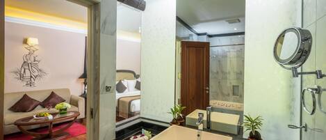 A modern bathroom with a large sink, mirror, and shower.