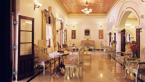 A spacious room with ornate furniture, a chandelier, and a polished floor. - Manor House, Kandy, LKA (Harispattuwa)