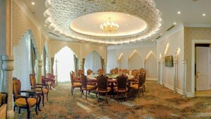 A spacious dining area with ornate chandeliers, patterned carpet, and traditional decor. - Long Wish Hotel International (Jiangyin)