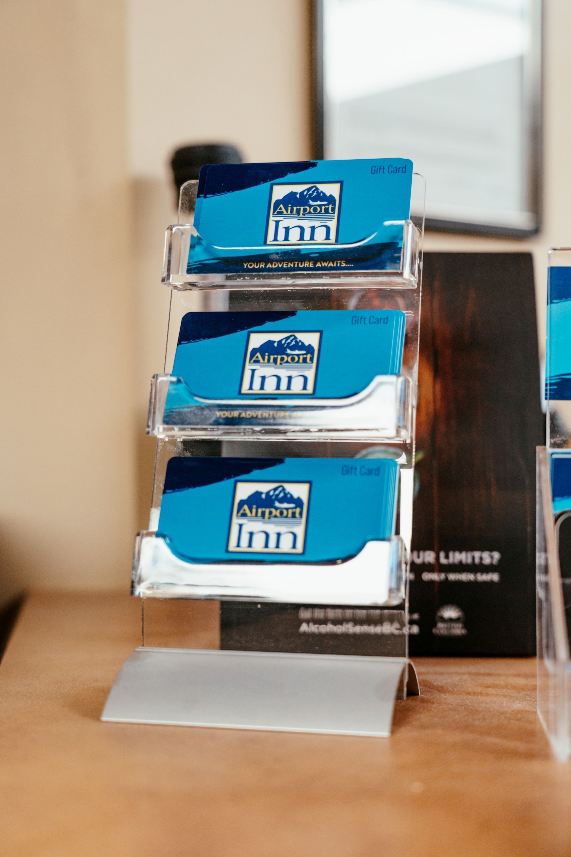 A display stand with three gift cards for a hotel.