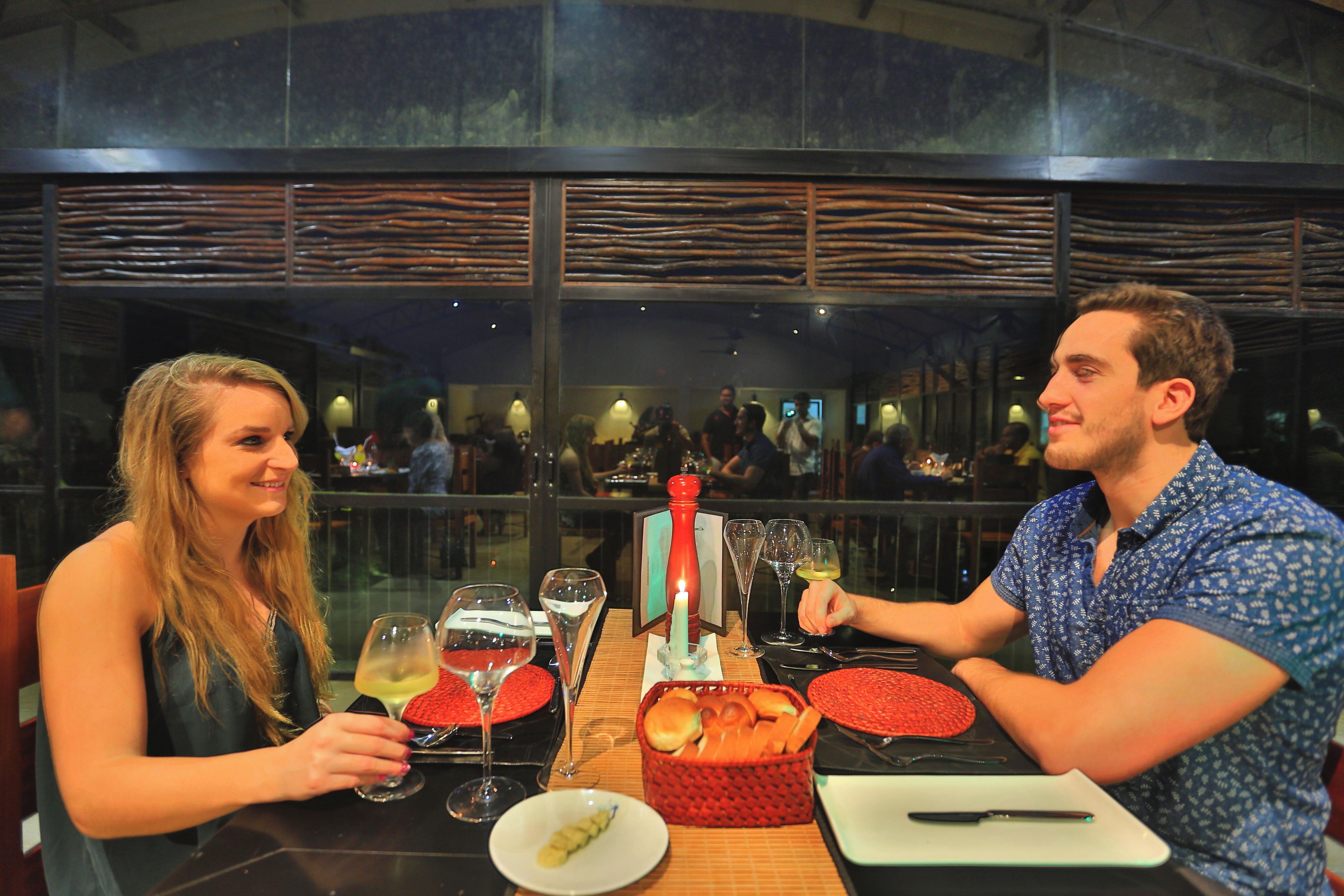 A restaurant with a modern interior, including a glass partition and a view of the cityscape.