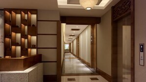 A hotel lobby with a long corridor, reception desk, and an elevator. - Yuanfeng Hebei Hotel (Lhasa)
