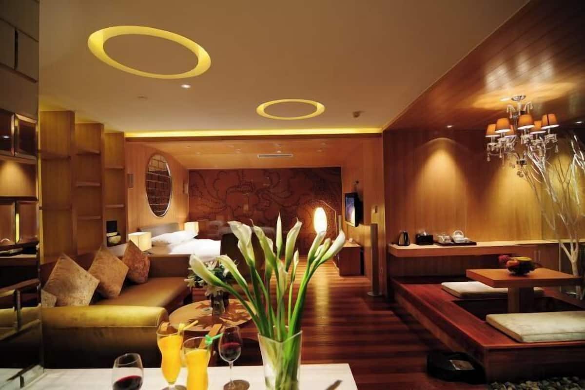 A modern interior with a sofa, a dining area, and a wall with a map design.