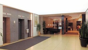 A lobby with a reception desk, a waiting area, and a staircase. - Sommerhaus Linz (Linz)