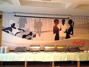A buffet setup with multiple serving stations and a wall mural. - Sommerhaus Linz (Linz)