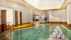 A hotel room with a pool, a bathroom, and a view of the kitchen. - Nalendra (Bandung)