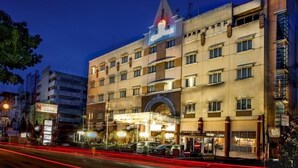 A multi-story hotel with a prominent entrance and a sign for 'NALENDOR'. - Nalendra (Bandung)