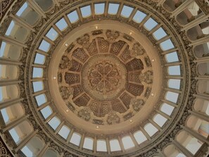 A grand, ornate ceiling with a circular design and multiple skylights. - The Palais Dago Hotel (Bandung)