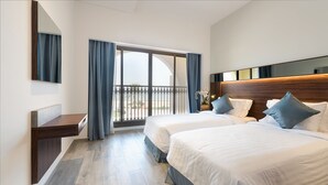 A hotel room with two beds, a wooden headboard, a large window with curtains, and a balcony. - Barracuda Beach Resort (Al Rafaah)