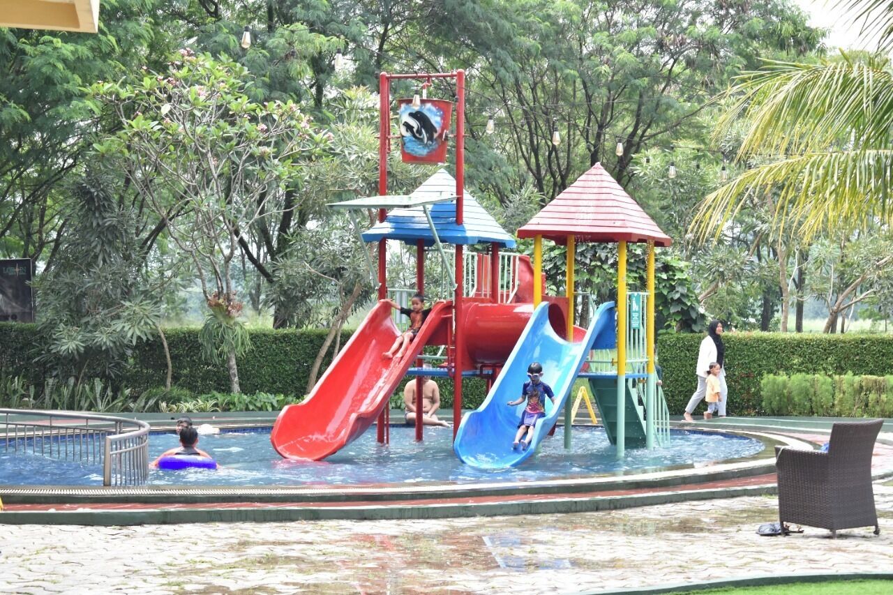 A water park with multiple slides and a small pool area.
