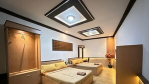 A bedroom with a bed, a wardrobe, a bedside table, and a ceiling light fixture. - Satria Cirebon (Cirebon)