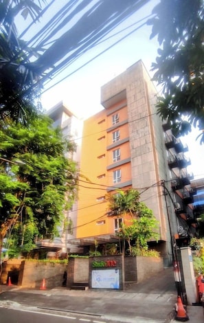 A multi-story building with a sign indicating a business or office space.