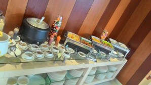 A buffet setup with various food items and beverages. - V Hotel Tebet, Jakarta (Jakarta)