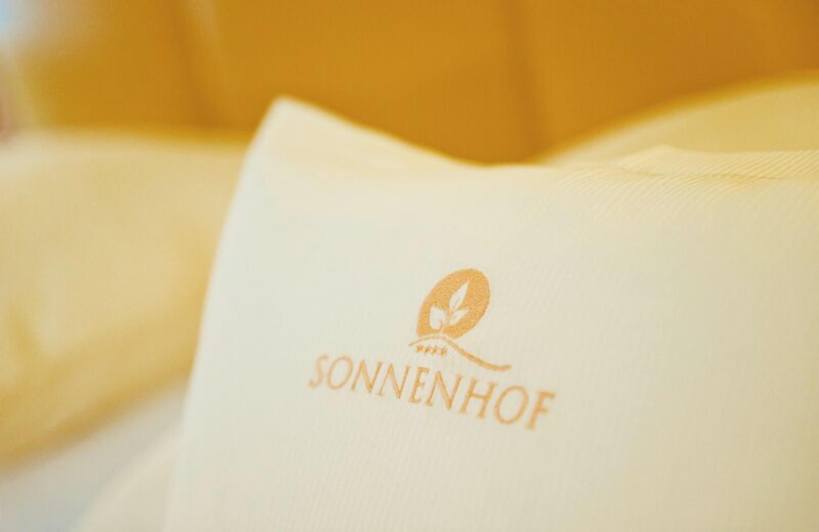 A pillow with the logo "SONNENHOF" on it.