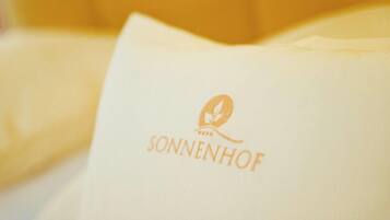 A pillow with the logo "SONNENHOF" on it.