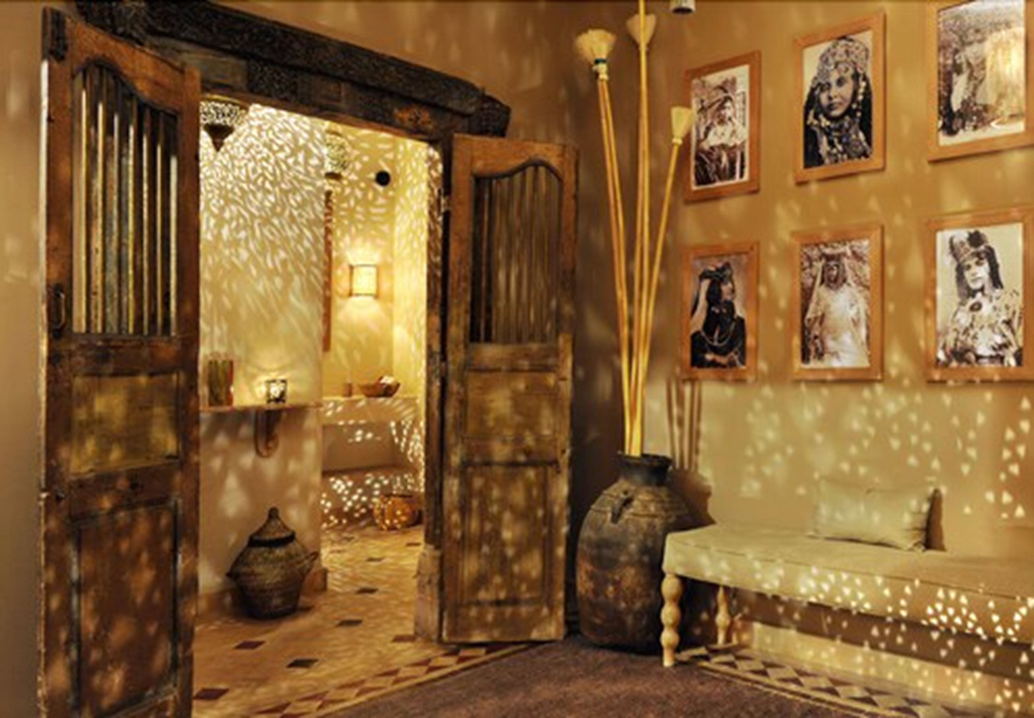 An interior with a traditional design, featuring wooden doors, a bench, and wall-mounted pictures.