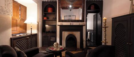 A traditional interior with a fireplace, seating area, and decorative elements.
