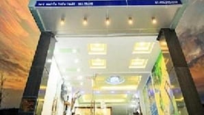 A hotel with a modern design, featuring a prominent sign with the hotel name and a logo. - Remi hotel (Nha Trang)