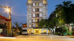 A multi-story hotel with a sign reading "NAM HOA HOTEL" at the top. - Tam Coc Nam Hoa Hotel and Spa (Nam Hoa Lu)