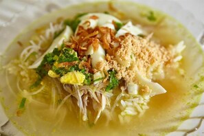 A bowl of noodle soup with toppings. - Banjarmasin Internasional (Banjarmasin)