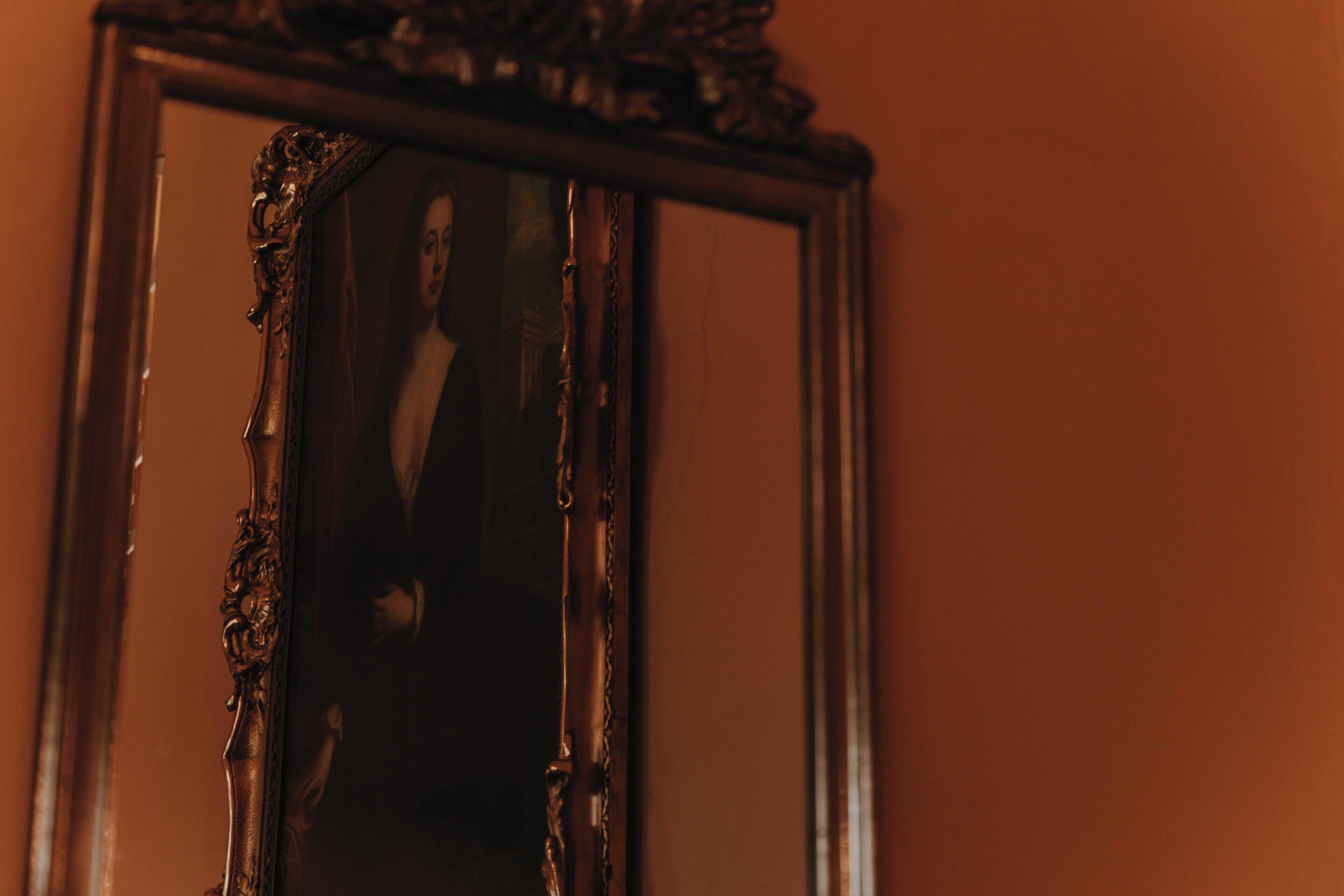 A mirror with a damaged frame.